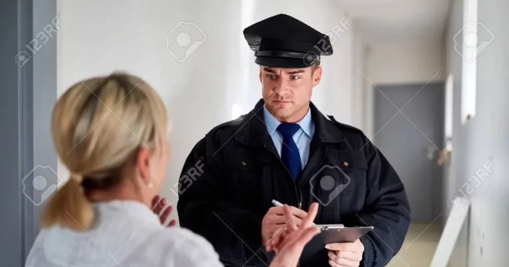 pic of police officer speaking to woman at the door to her home