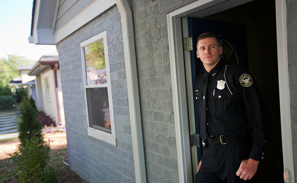 police officer at door to a home